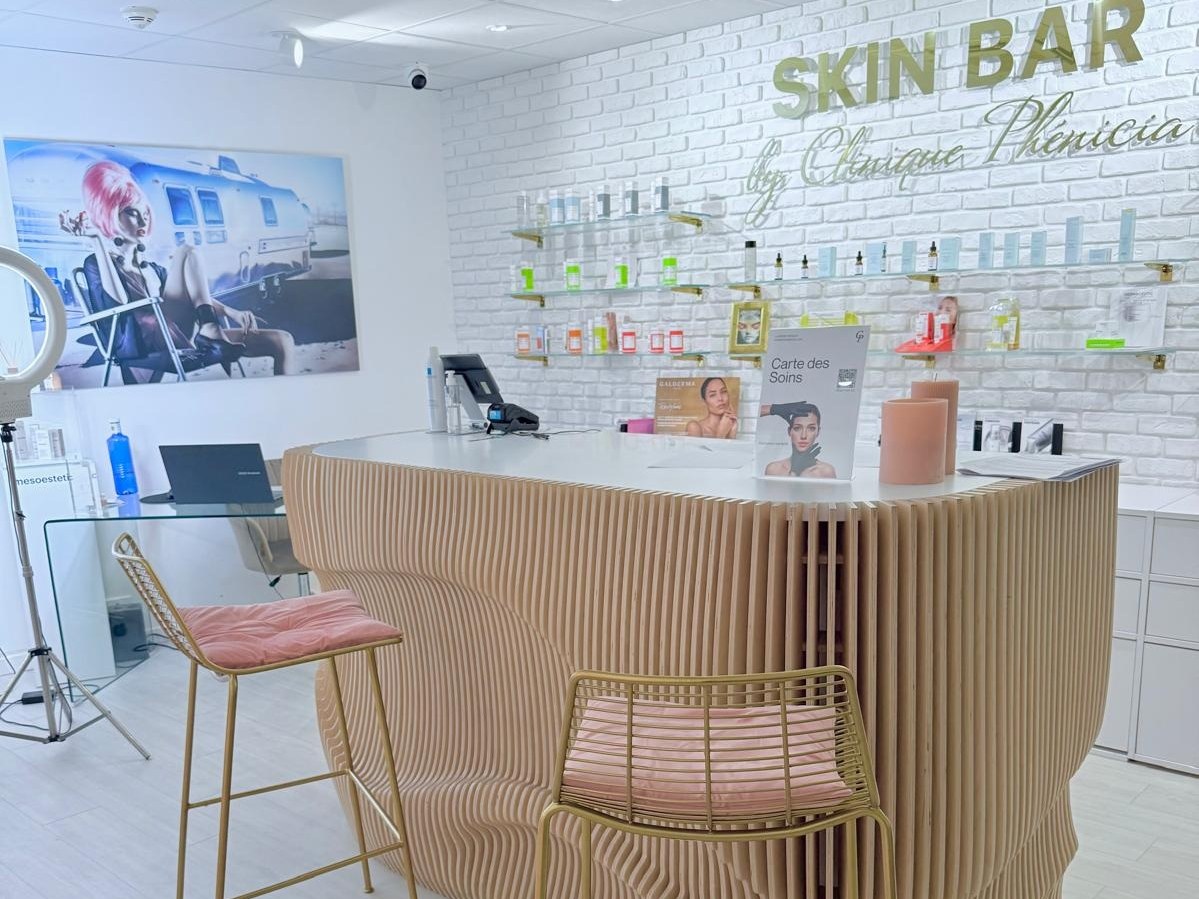 The Skin Bar reception at Clinique Phénicia: counter, skincare displays and wall signage